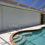Storm shuttered home by pool