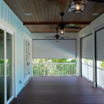 Inside a partially shuttered balcony area of a summer home