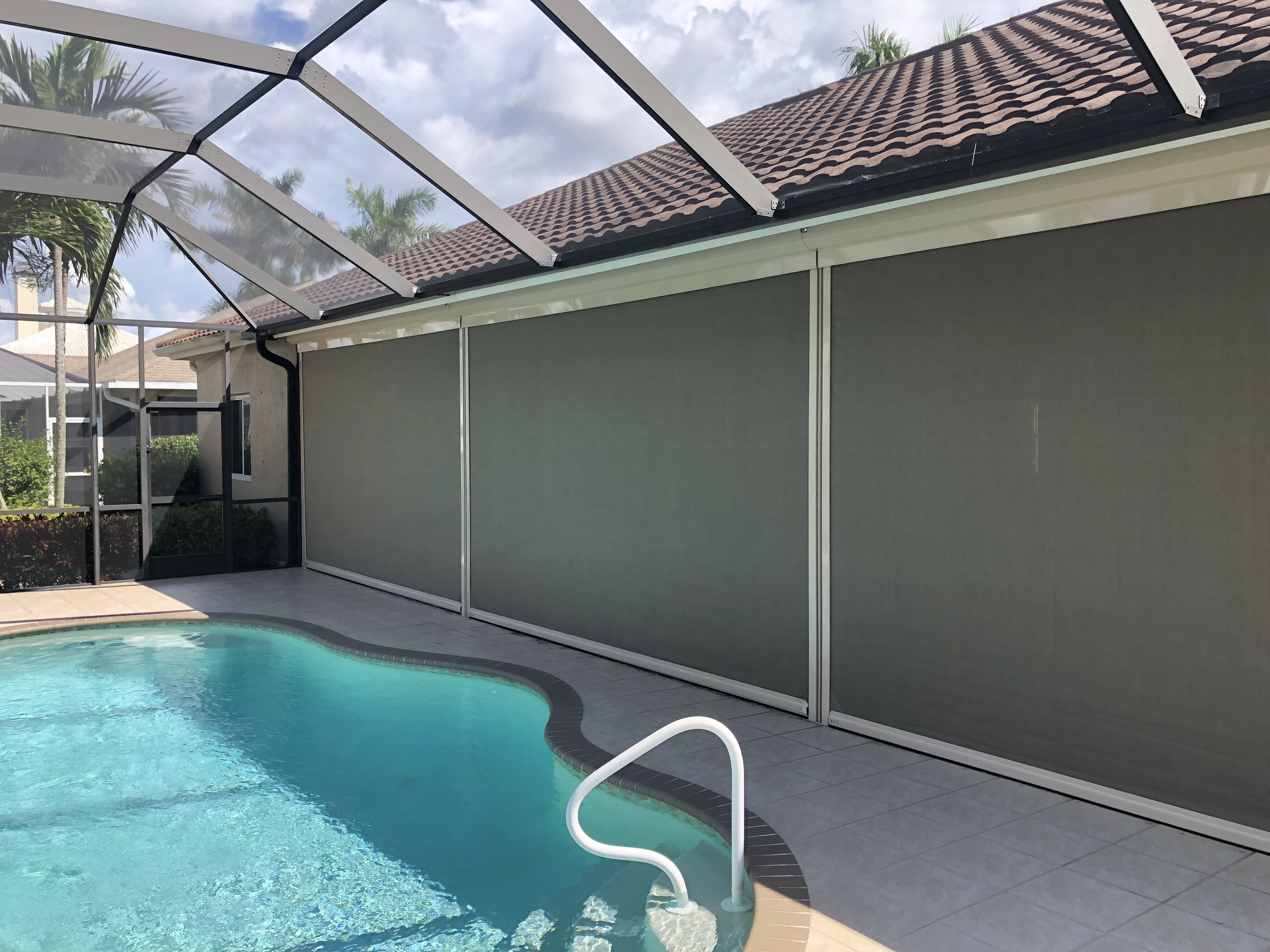 line of hurricane screens by pool - hurricane screen installation concept image